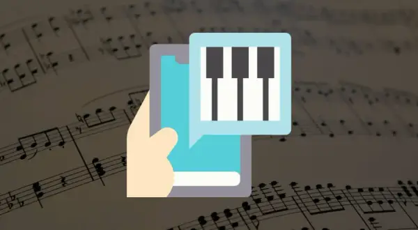 Dłoń trzyma smartfon z ikoną klawiatury pianina na tle nut. Aplikacja do nauki gry na pianinie.